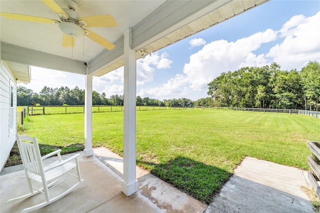 view of yard featuring a rural view, a patio, and ceiling fan