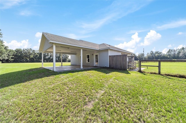 back of house featuring ceiling fan, a yard, and a patio area