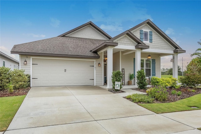 view of front of property with covered porch and a garage