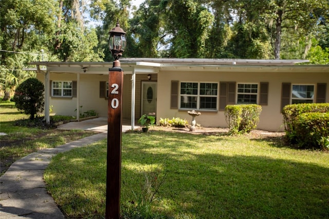 single story home featuring a front yard