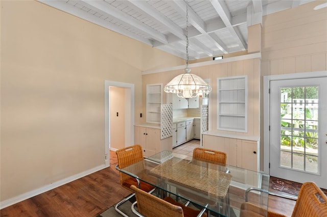 dining room featuring light wood-type flooring, lofted ceiling with beams, a chandelier, and wooden ceiling