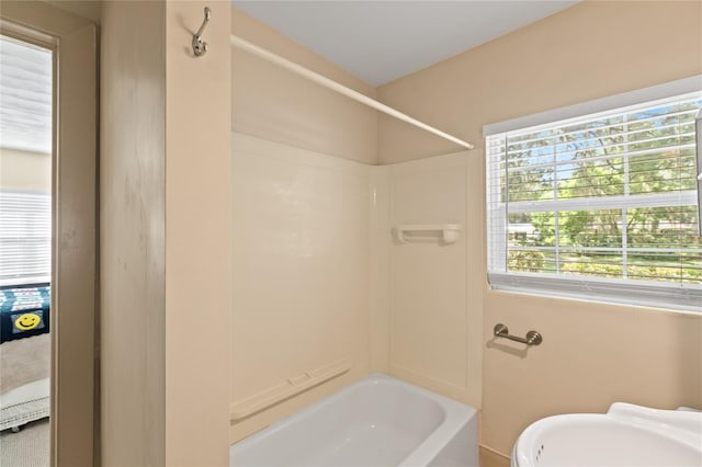 full bathroom featuring bathing tub / shower combination, toilet, and sink