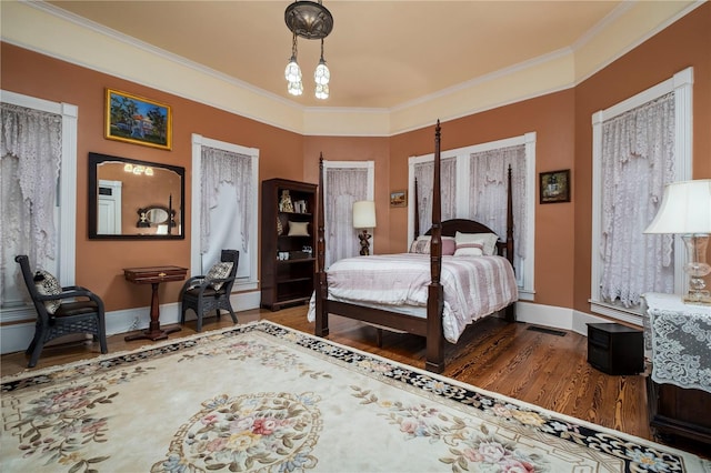 bedroom featuring ornamental molding and hardwood / wood-style floors