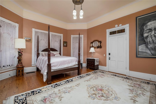 bedroom featuring ornamental molding and dark wood-type flooring