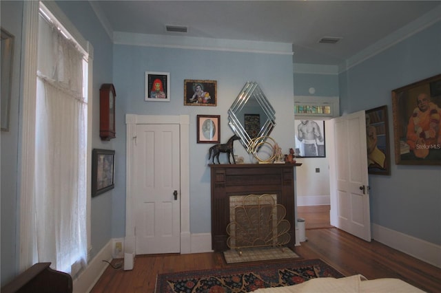 living room featuring ornamental molding and dark hardwood / wood-style flooring