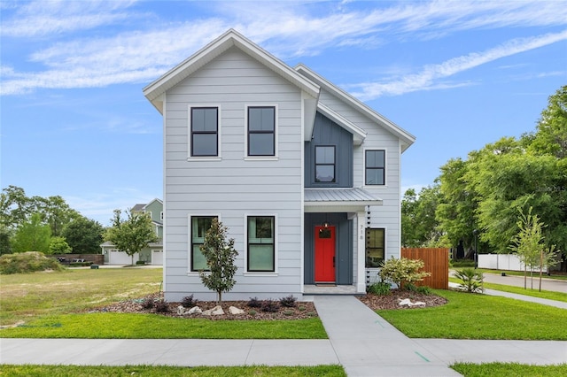 view of front of home with fence and a front lawn