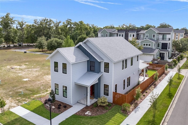 view of front of property with fence, a residential view, and a front yard