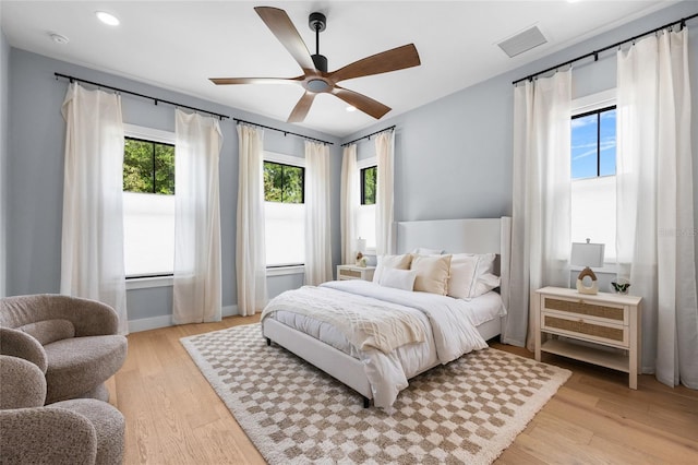 bedroom with recessed lighting, light wood-style flooring, visible vents, and a ceiling fan