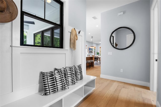 mudroom featuring baseboards, wood finished floors, visible vents, and recessed lighting