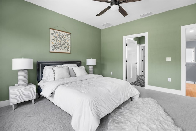 bedroom with ceiling fan, baseboards, and visible vents