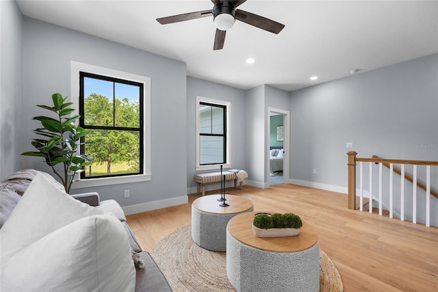 living area featuring recessed lighting, wood finished floors, a ceiling fan, and baseboards