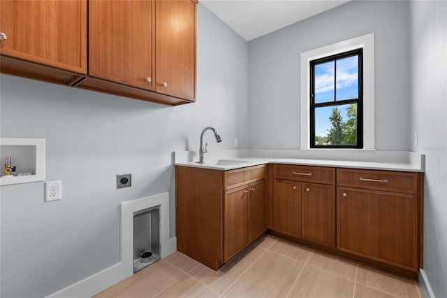 laundry room with hookup for a washing machine, a sink, electric dryer hookup, light tile patterned flooring, and cabinet space