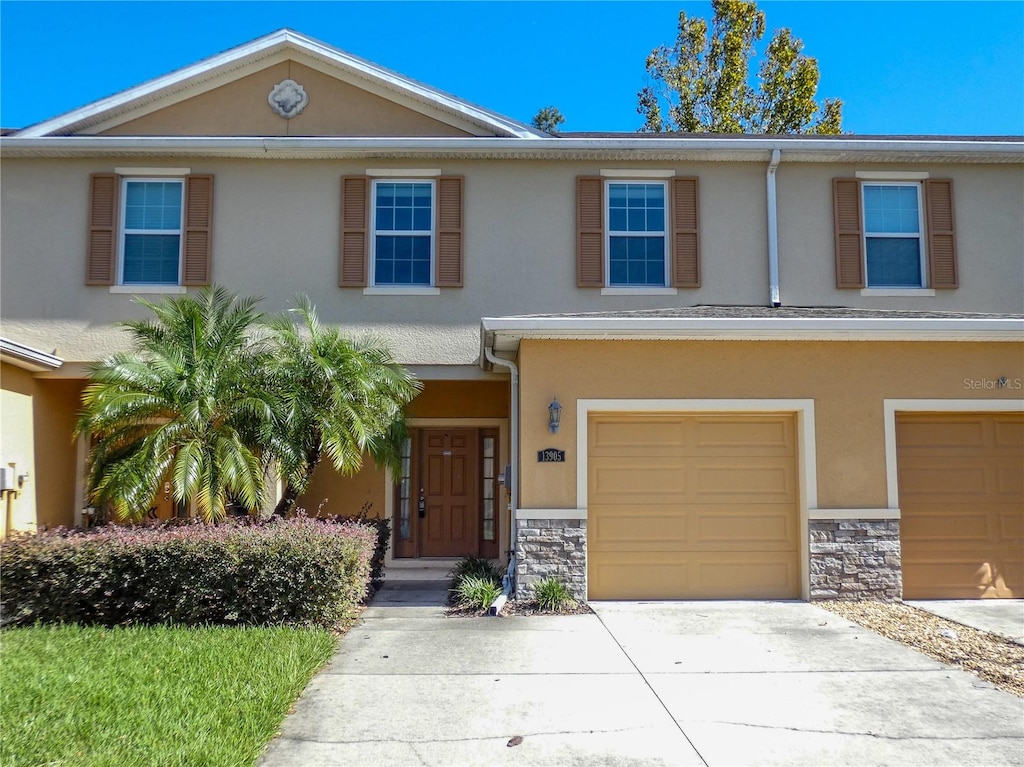 townhome / multi-family property featuring a garage