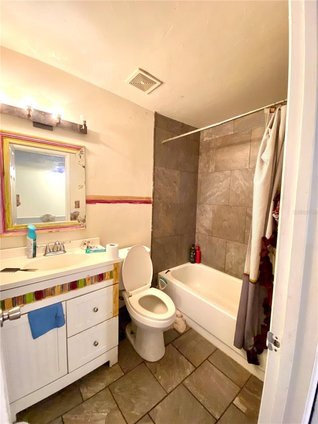 full bathroom with shower / bath combo, vanity, and toilet