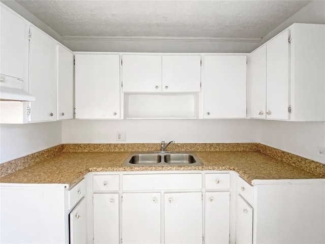 kitchen featuring sink, a textured ceiling, and white cabinets