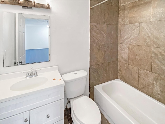 full bathroom with vanity, tiled shower / bath combo, and toilet