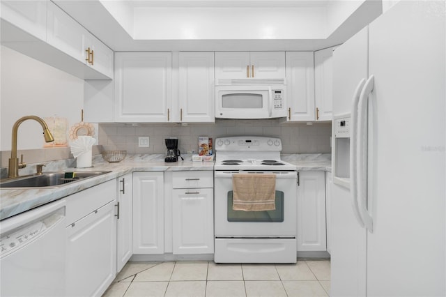 kitchen featuring tasteful backsplash, sink, white cabinetry, white appliances, and light tile patterned floors