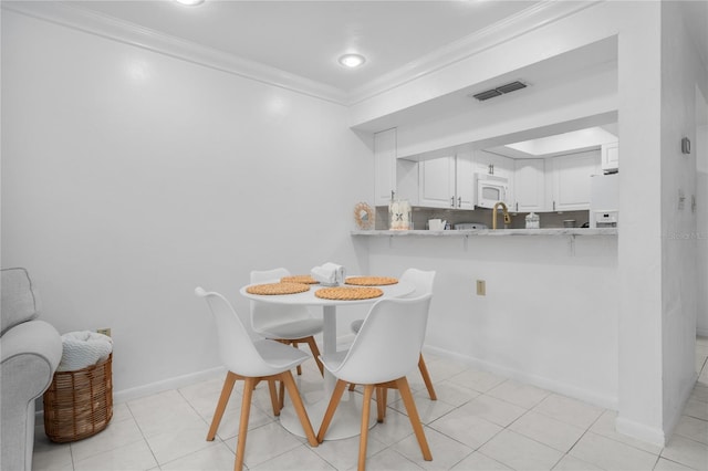 tiled dining space with crown molding