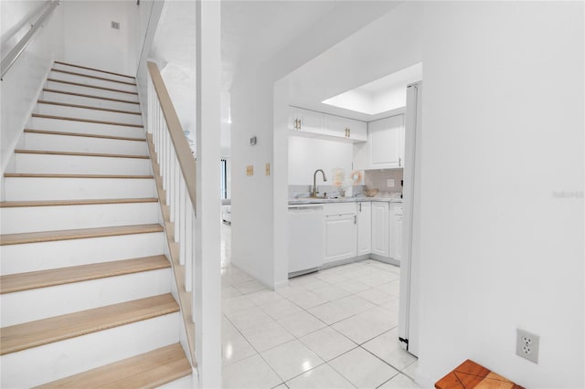 staircase with sink and tile patterned flooring