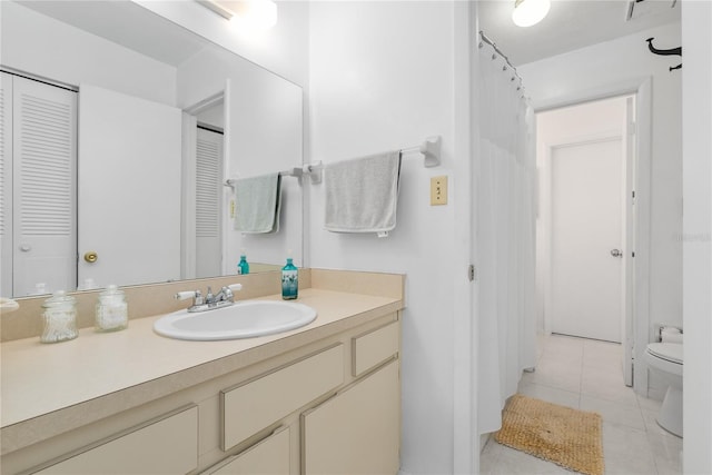 bathroom with tile patterned flooring, vanity, and toilet