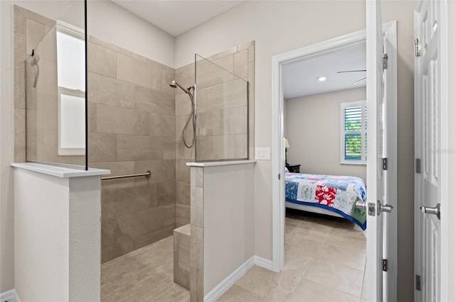 bathroom with a tile shower and tile patterned flooring