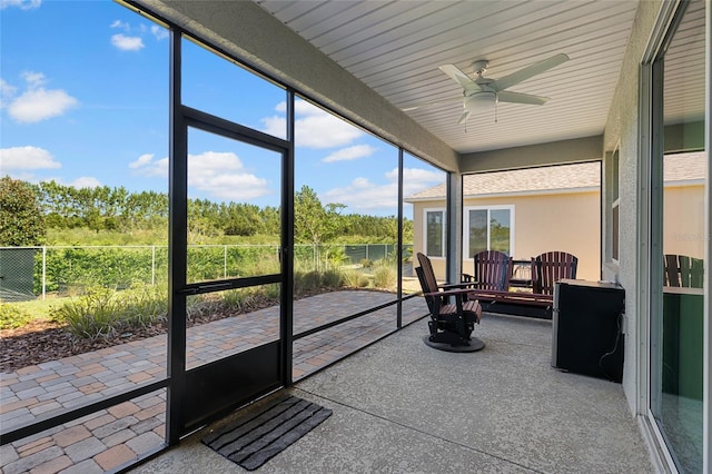 sunroom featuring ceiling fan