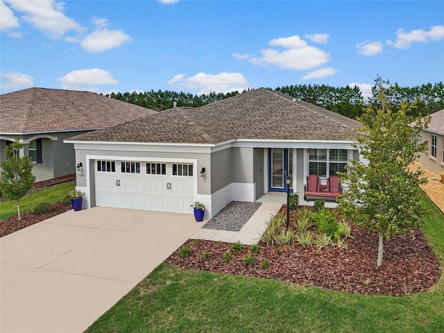 ranch-style house featuring covered porch, a front yard, and a garage