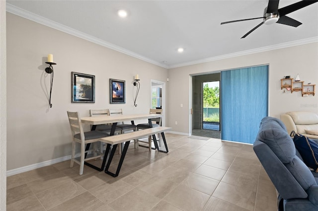 tiled dining space featuring ceiling fan and ornamental molding