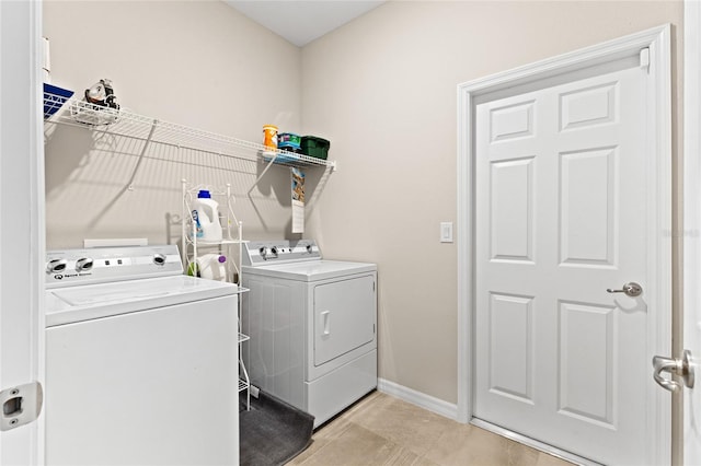 laundry room with light tile patterned floors and washer and dryer