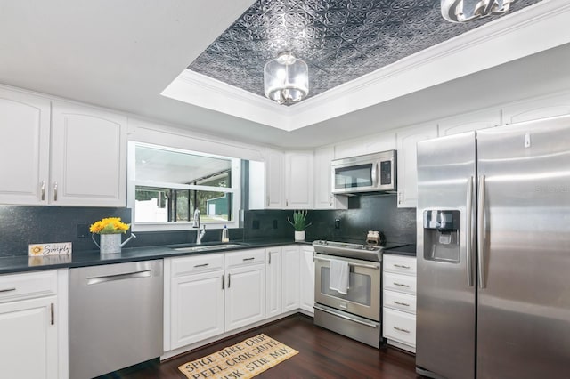 kitchen with appliances with stainless steel finishes, white cabinetry, and sink