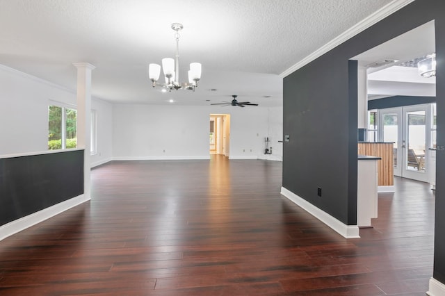 empty room with ceiling fan with notable chandelier, a textured ceiling, dark hardwood / wood-style floors, and french doors