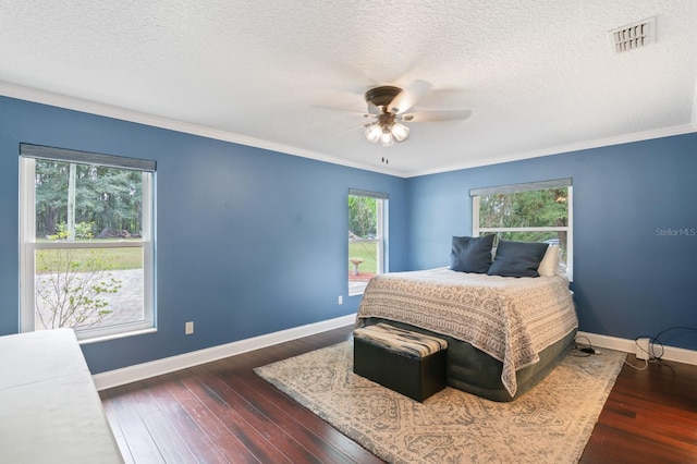 bedroom featuring ornamental molding, a textured ceiling, ceiling fan, and dark hardwood / wood-style flooring