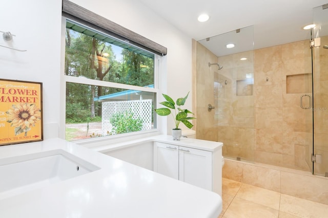 bathroom with shower with separate bathtub, plenty of natural light, and tile patterned floors