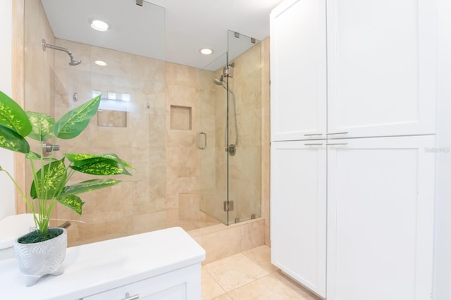 bathroom with walk in shower and tile patterned floors