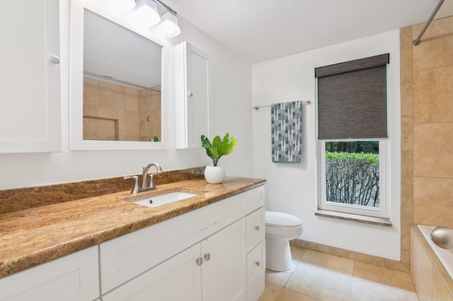 full bathroom with tile patterned floors, tiled shower / bath combo, vanity, and toilet