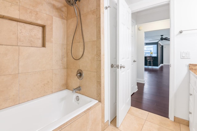 bathroom with ceiling fan, tiled shower / bath, hardwood / wood-style flooring, and vanity