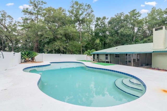 view of pool featuring a patio and a sunroom