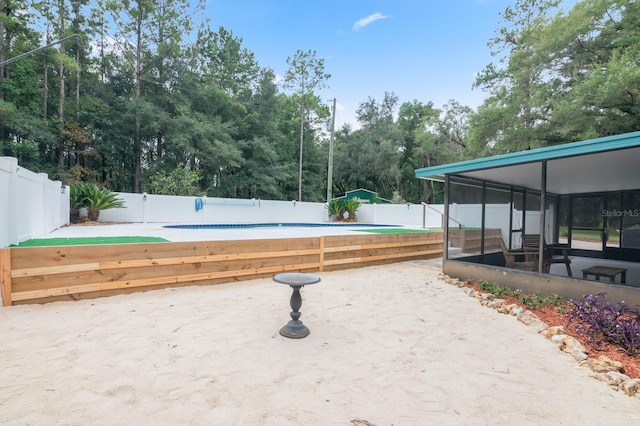 view of yard featuring a sunroom and a patio area