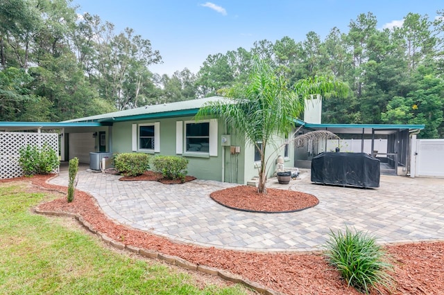 back of house featuring cooling unit and a patio