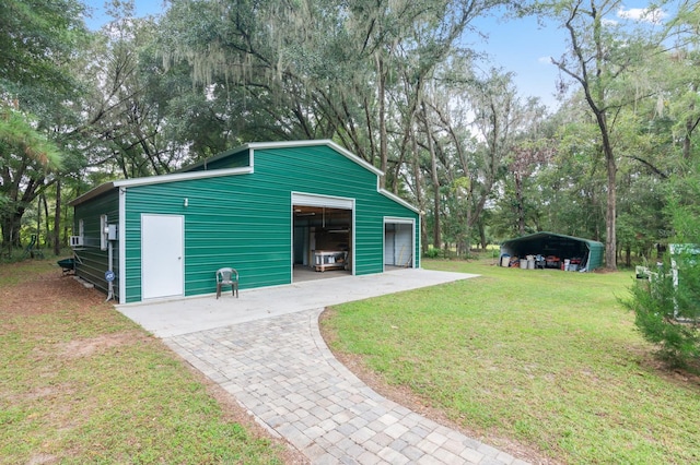 exterior space with a lawn, a carport, and a garage