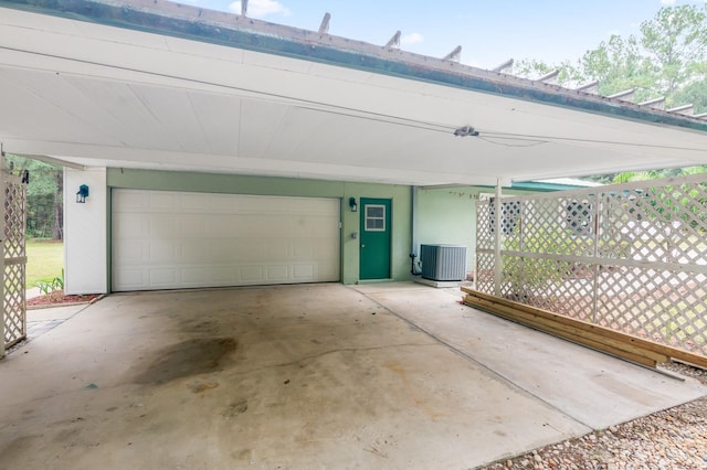 garage with a carport and central AC