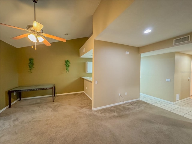 tiled spare room featuring baseboards, a ceiling fan, visible vents, and carpet flooring