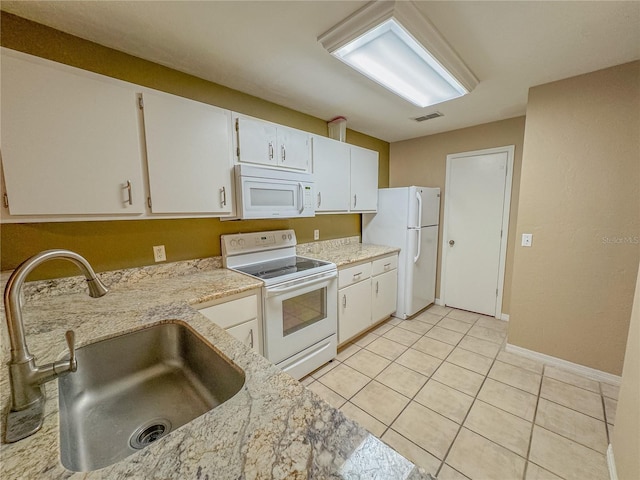 kitchen with white cabinets, a sink, visible vents, white appliances, and light tile patterned floors