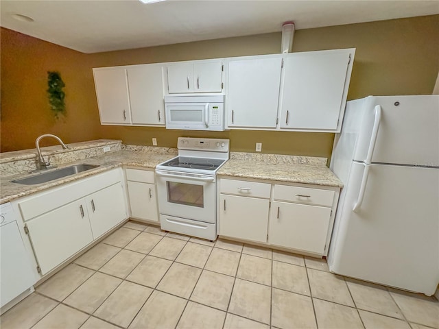 kitchen featuring sink, white appliances, and white cabinetry