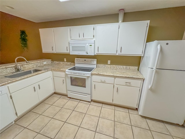 kitchen featuring white cabinets, light countertops, white appliances, and a sink