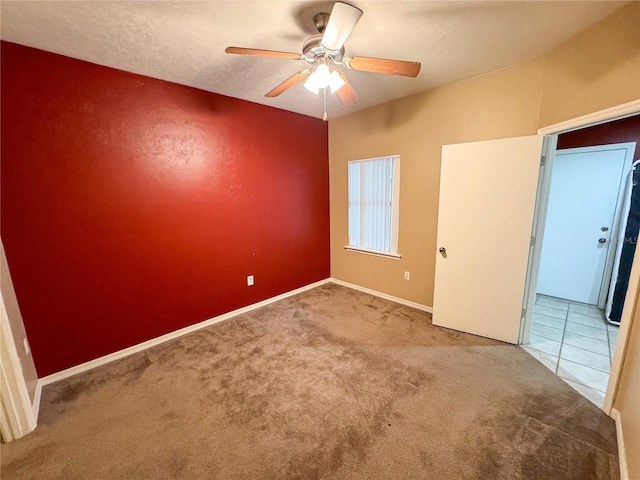 unfurnished bedroom featuring ceiling fan and carpet floors