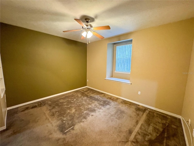 unfurnished room with baseboards, a ceiling fan, and carpet