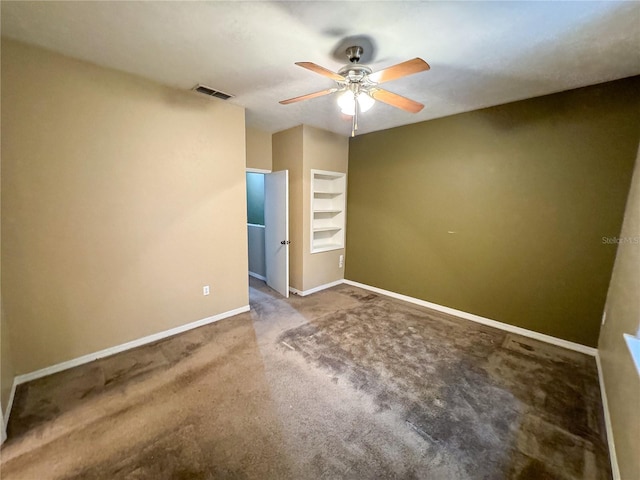 empty room featuring ceiling fan, baseboards, carpet flooring, and visible vents