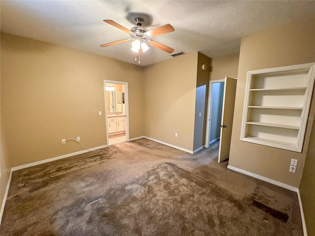 unfurnished room with carpet flooring, ceiling fan, and built in features