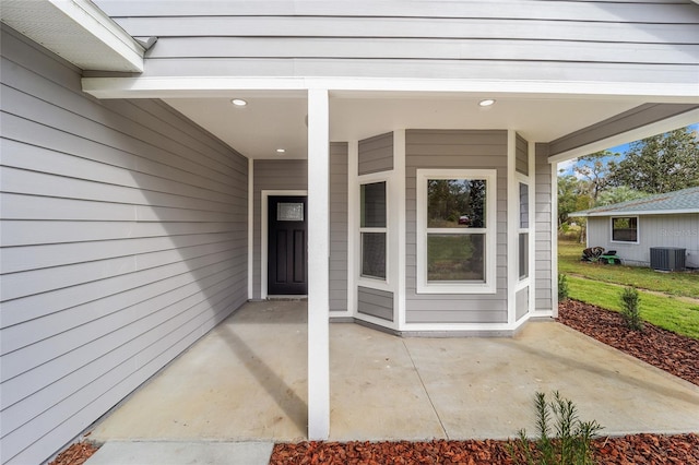 entrance to property with a patio and central AC